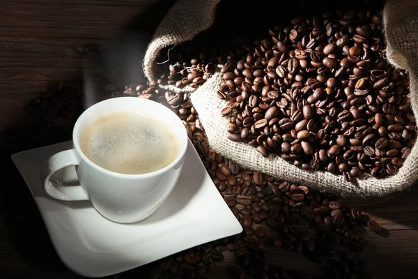 Coffee with sack of coffee beans — Stock Photo, Image