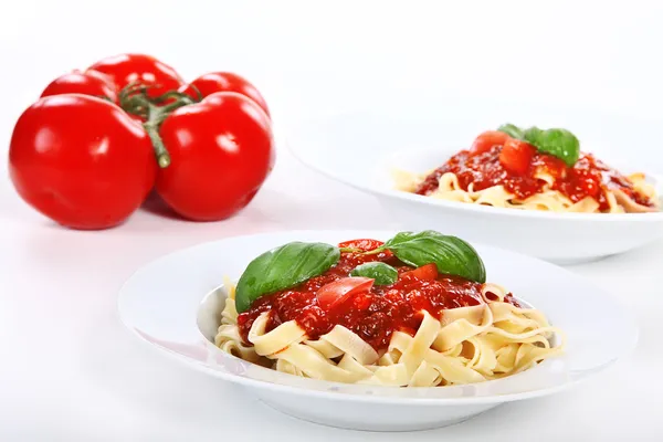 Plates of pasta with tomato — Stock Photo, Image