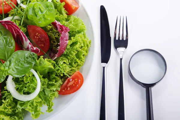 Salad with vegetables and magnifier — Stock Photo, Image