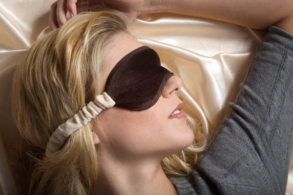 Woman sleeping in bed with eye mask — Stock Photo, Image