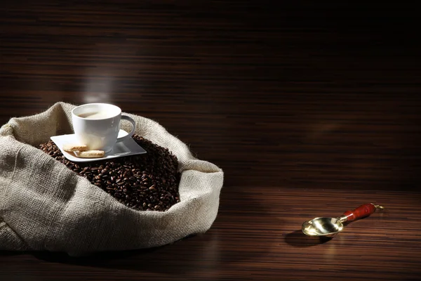 Coffee with sack of coffee beans — Stock Photo, Image