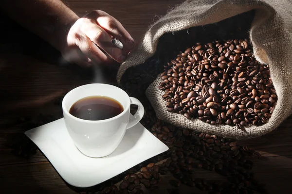 Coffee with sack of coffee beans — Stock Photo, Image