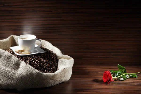Coffee with sack of coffee beans and rose — Stock Photo, Image