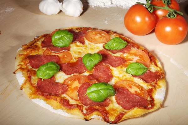 Pizza with sausage and tomatoes — Stok fotoğraf