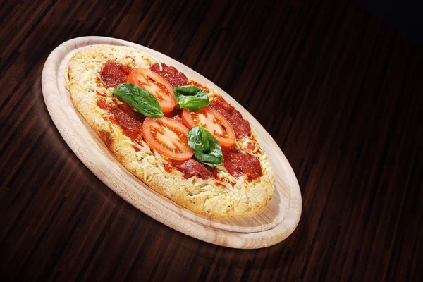 Pizza with sausage and tomatoes — Stok fotoğraf