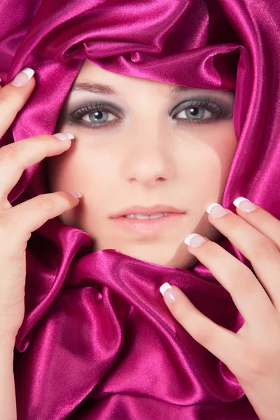 Blonde girl in a pink curtain — Stock Photo, Image