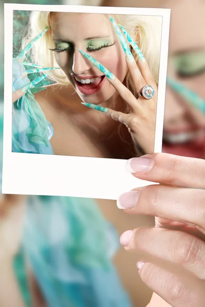 Woman's hand with a photo — Stock Photo, Image