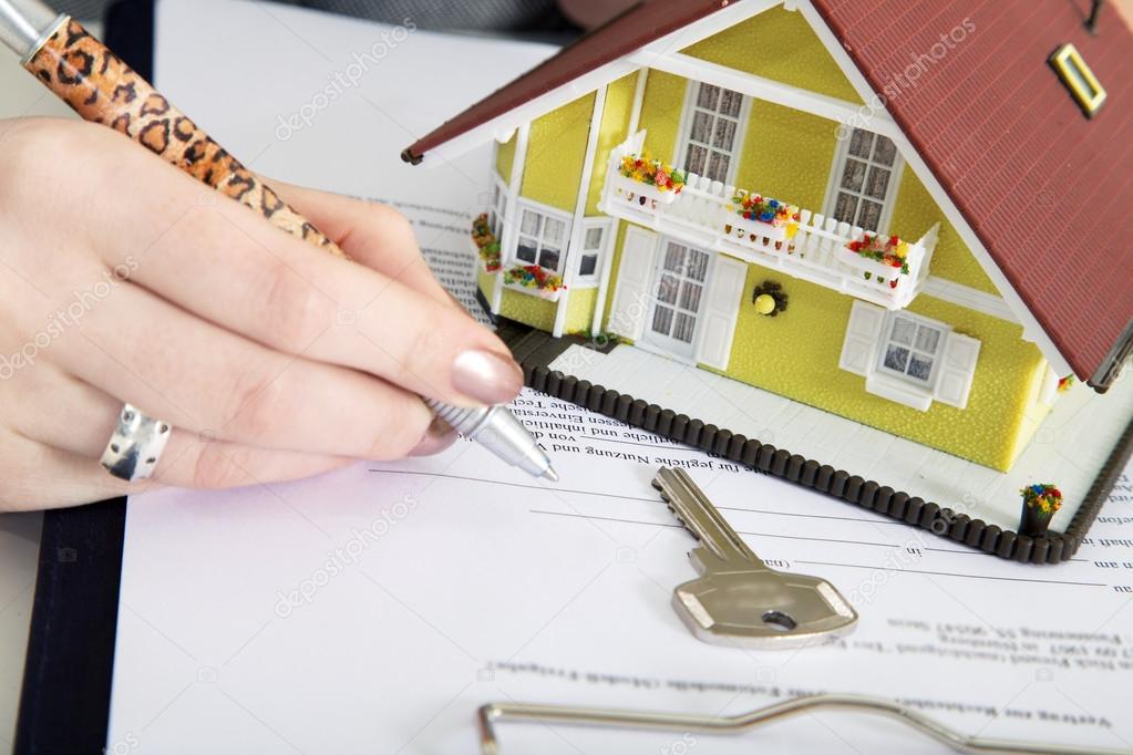 Woman signs documents at home