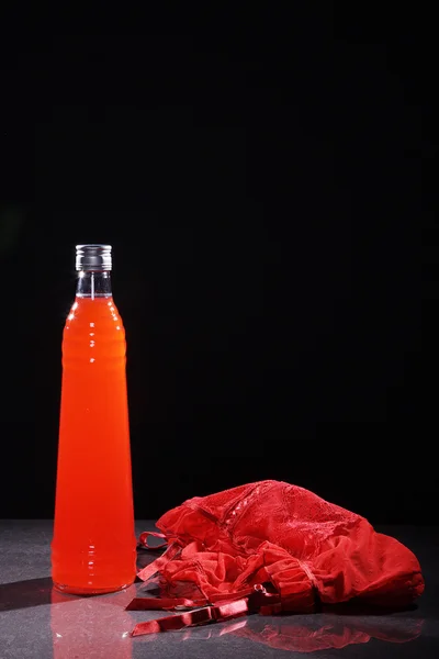 Bottle of juice and a handbag — Stock Photo, Image