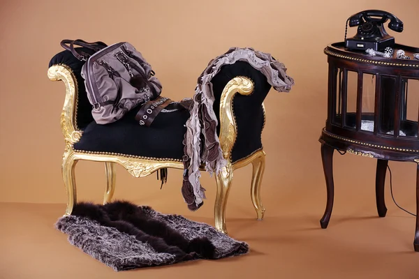 Bag with a fur coat on a chair — Stock Photo, Image