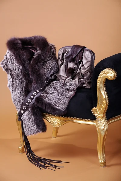 Bag with a fur coat on a chair — Stock Photo, Image