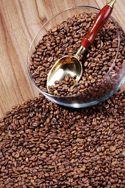 Coffee beans with a spoon — Stock Photo, Image