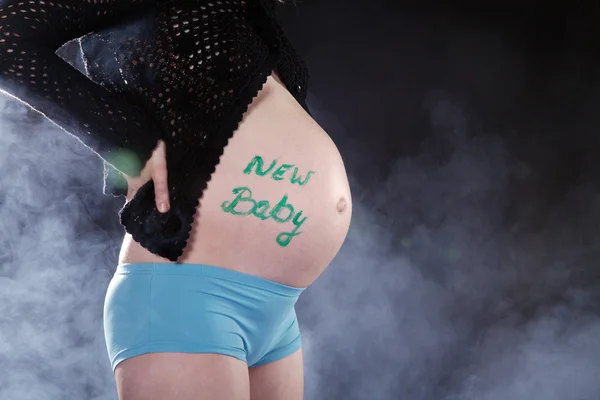 A pregnant woman with a sign on the stomach — Stock Photo, Image