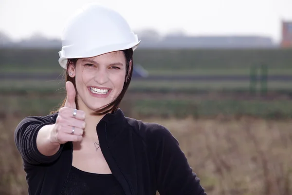 Architect girl shows a sign — Stock Photo, Image