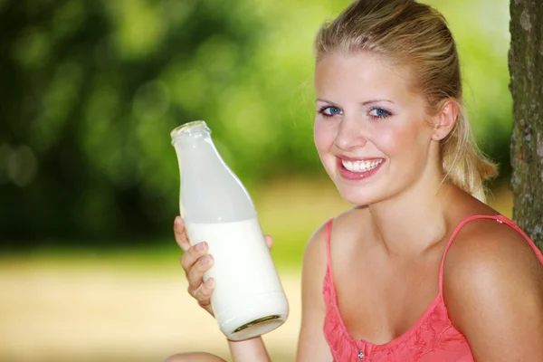 Blonde girl drinks milk — Stock Photo, Image