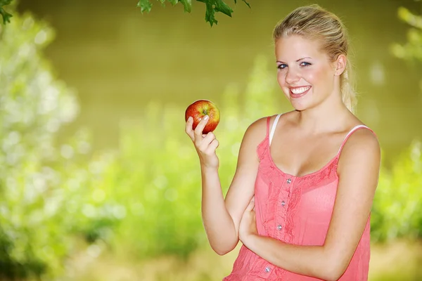 Blonde girl with apple — Stock Photo, Image