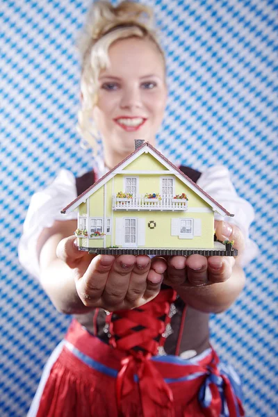 Blonde girl holding a toy house — Stock Photo, Image