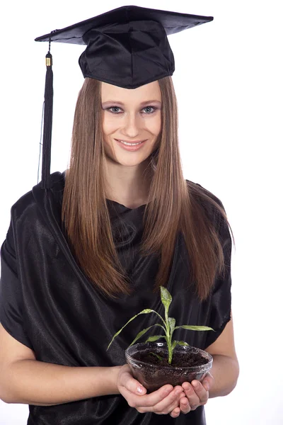 Graduate student with a plant in a glass pot — Stock Photo, Image
