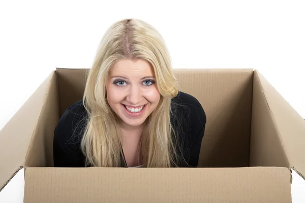 Blond girl sitting in a box Stock Image