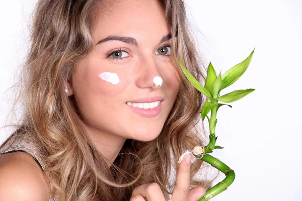 Beautiful woman using a skin care product — Stock Photo, Image