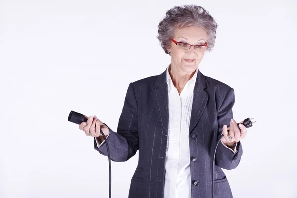 Mujer enchufando cable eléctrico — Foto de Stock