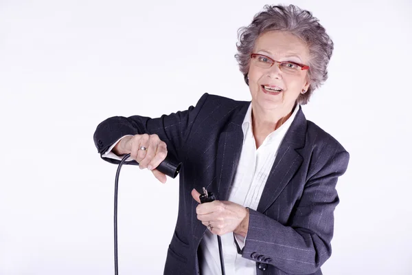 Woman plugging electric cord — Stock Photo, Image