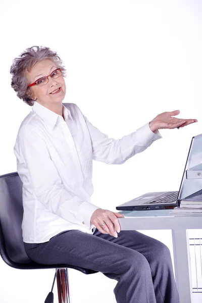 Allvarliga senior kvinna med hennes laptop sitter — Stockfoto