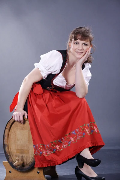 Girl with a barrel of wine — Stock Photo, Image