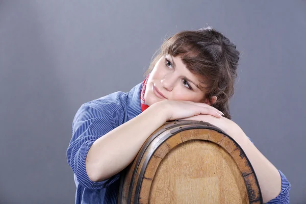 Girl with a barrel of wine — Stock Photo, Image