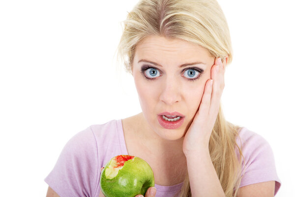 Blond woman eat green apple