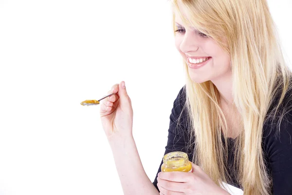 Blonde girl with honey — Stock Photo, Image