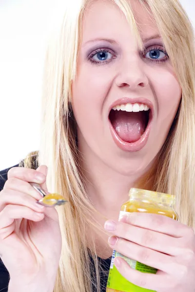 Blonde girl with honey — Stock Photo, Image