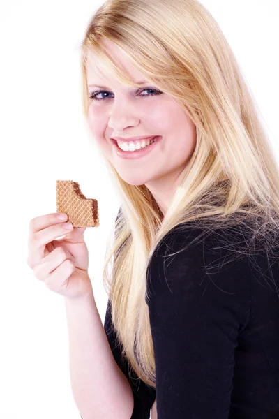 Blond meisje eten cookies — Stockfoto