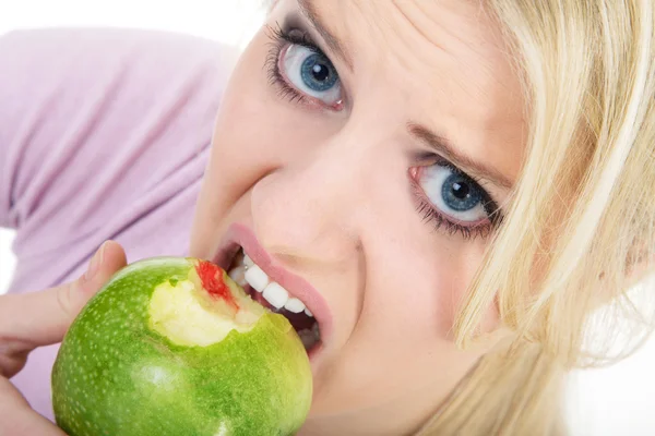 Mulher loira comer maçã verde — Fotografia de Stock