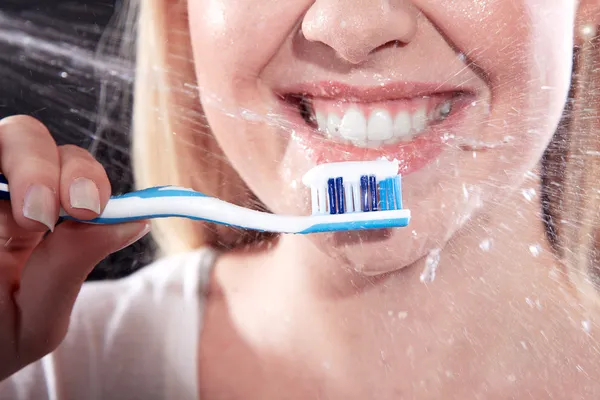 Closeup portrait of beautiful young woman brushing her teeth — Stock Photo, Image