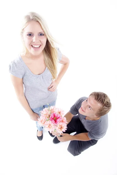 Happy young couple with flowers — Stock Photo, Image