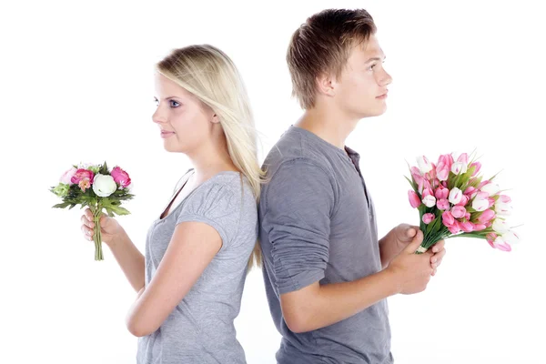 Happy young couple with flowers — Stock Photo, Image