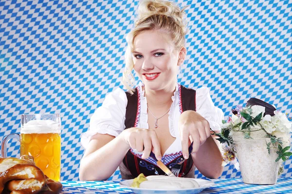 Girl in traditional dress breakfast — Stock Photo, Image