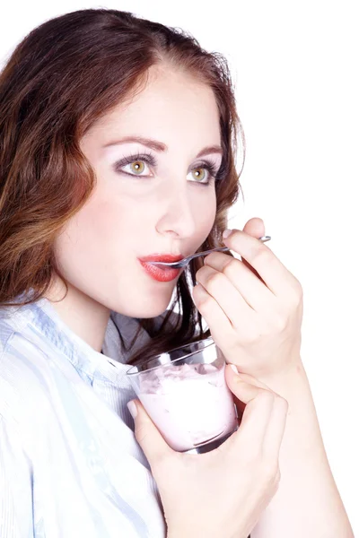 Young caucasian woman eating yogurt — Stock Photo, Image