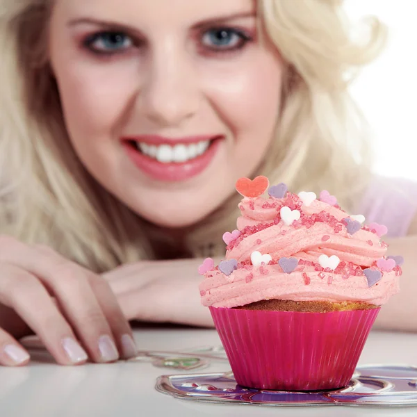 Young smiling woman with cupcake — Stockfoto