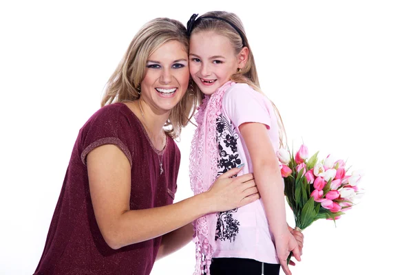 Mom and daughter with a bouquet of tulips — Stock Photo, Image