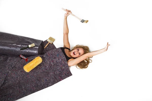 Blonde girl with the tools on the linoleum — Stock Photo, Image