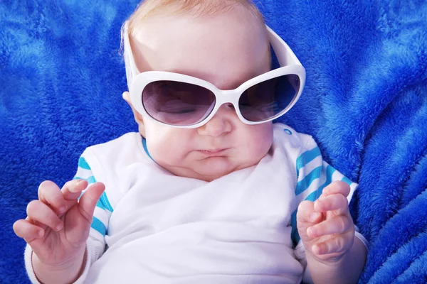 Happy little child wrapped in blue towel Stock Picture