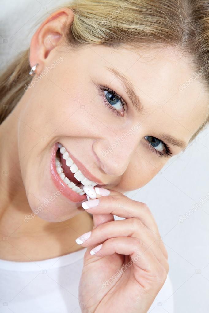 Blonde girl with chewing gum