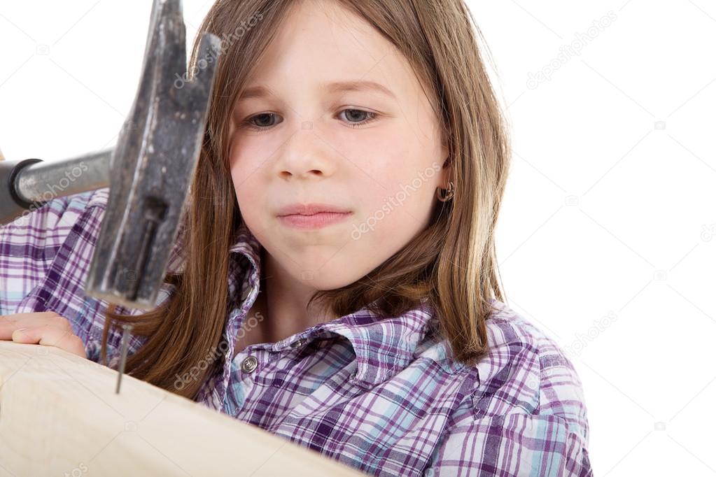 Young girl with hammer and nail
