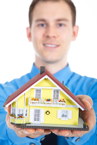 Young business man with miniature house — Stock Photo, Image