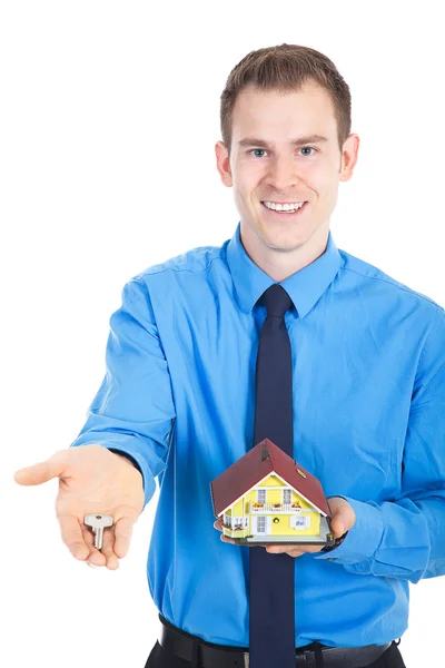 Young business man with miniature house — Stock Photo, Image