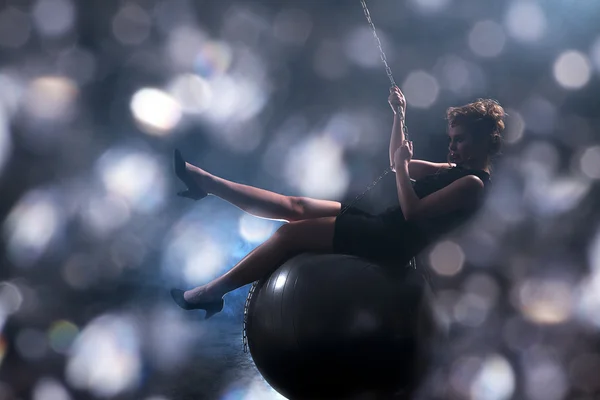 Sexy woman swinging on ball — Stock Photo, Image