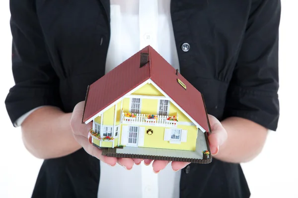 Businesswoman holding miniature house — Stock Photo, Image