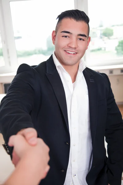 Businessman shakes hands with companion — Stock Photo, Image
